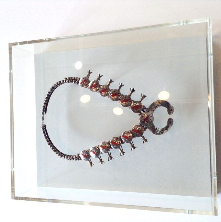 Necklace on a custom armature inside an acrylic wall case, SBAS Houston
