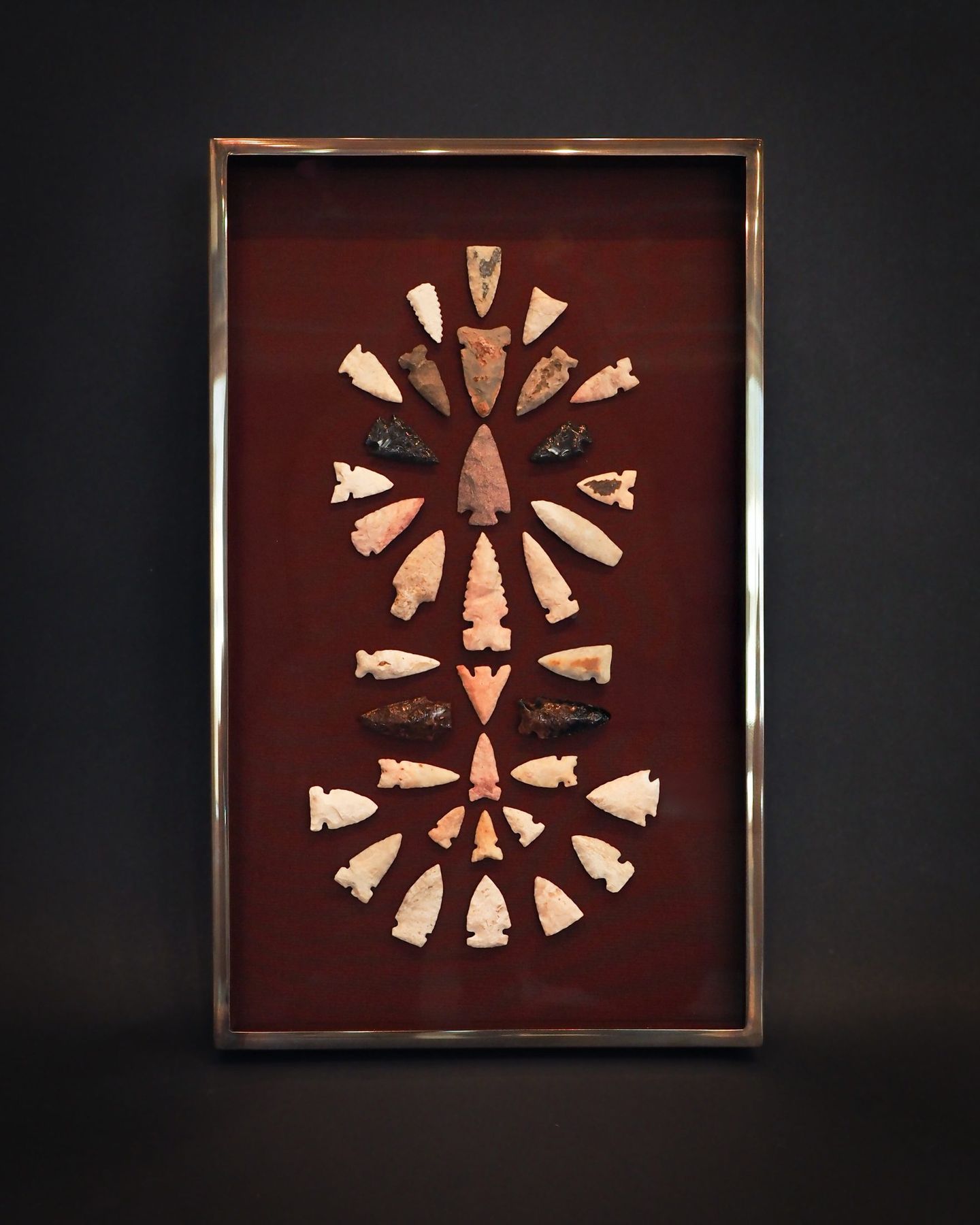 Arrowhead collection mounted in a brass-trimmed shadowbox frame, SBAS Houston