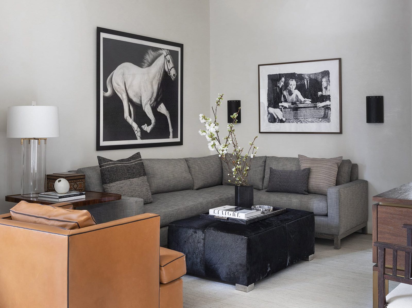 Den with framed black-and-white photography, a Chandos Interiors project framed by SBAS Houston