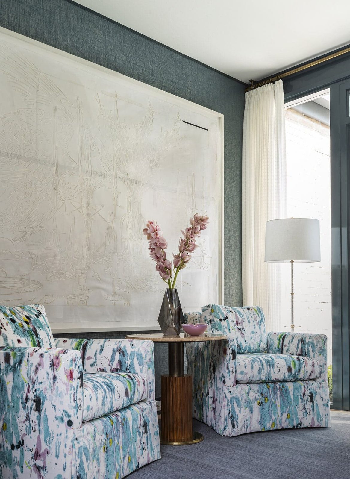 Oversized canvas in a minimal float frame beside curtainwall glass, framed by SBAS Houston