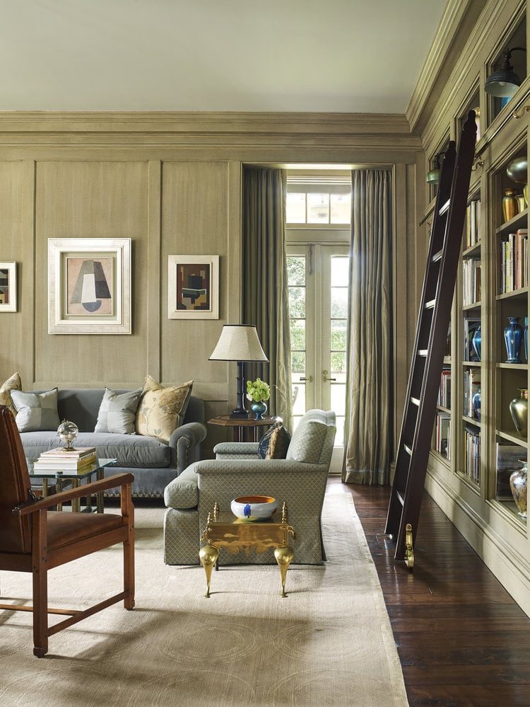 Paneled library hung with framed works in a collector's residence, framing by SBAS Houston