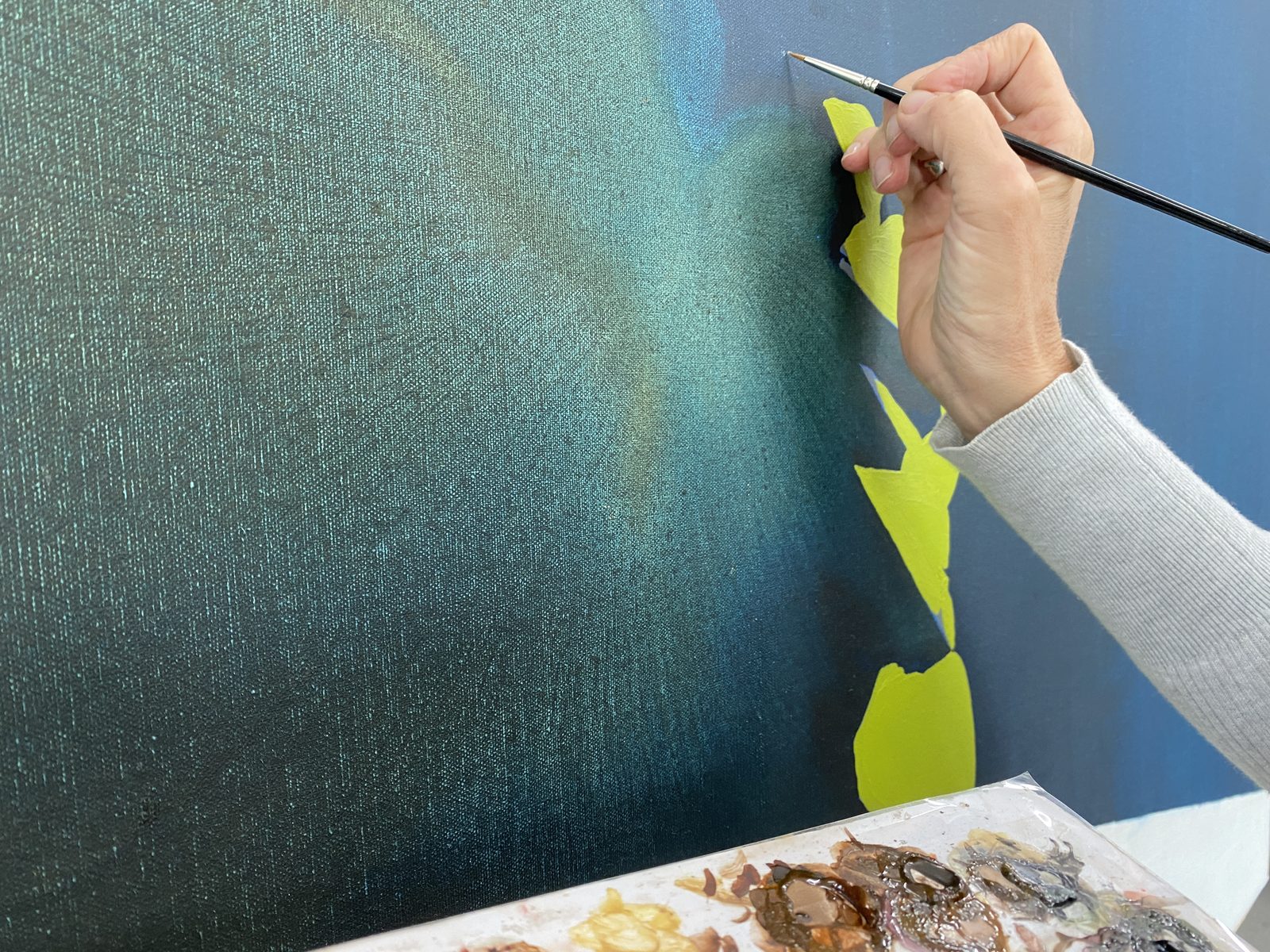 Conservator inpainting a canvas — specialist treatment coordinated by SBAS Houston