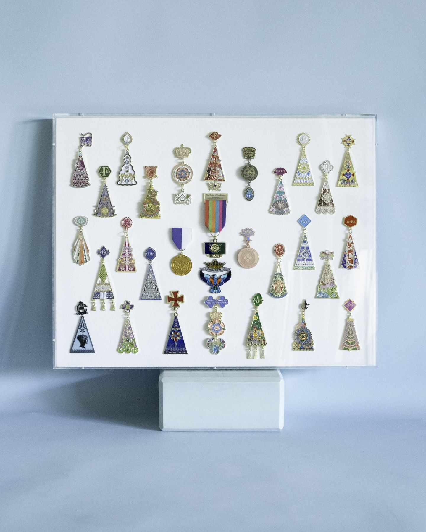 Custom acrylic display case presenting a mounted jewelry collection, fabricated by SBAS Houston