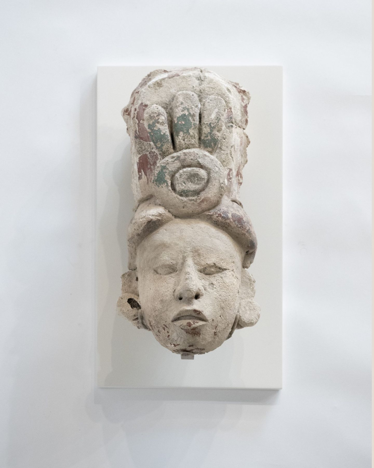 Pre-Columbian stone head on a custom wall mount fabricated by SBAS Houston
