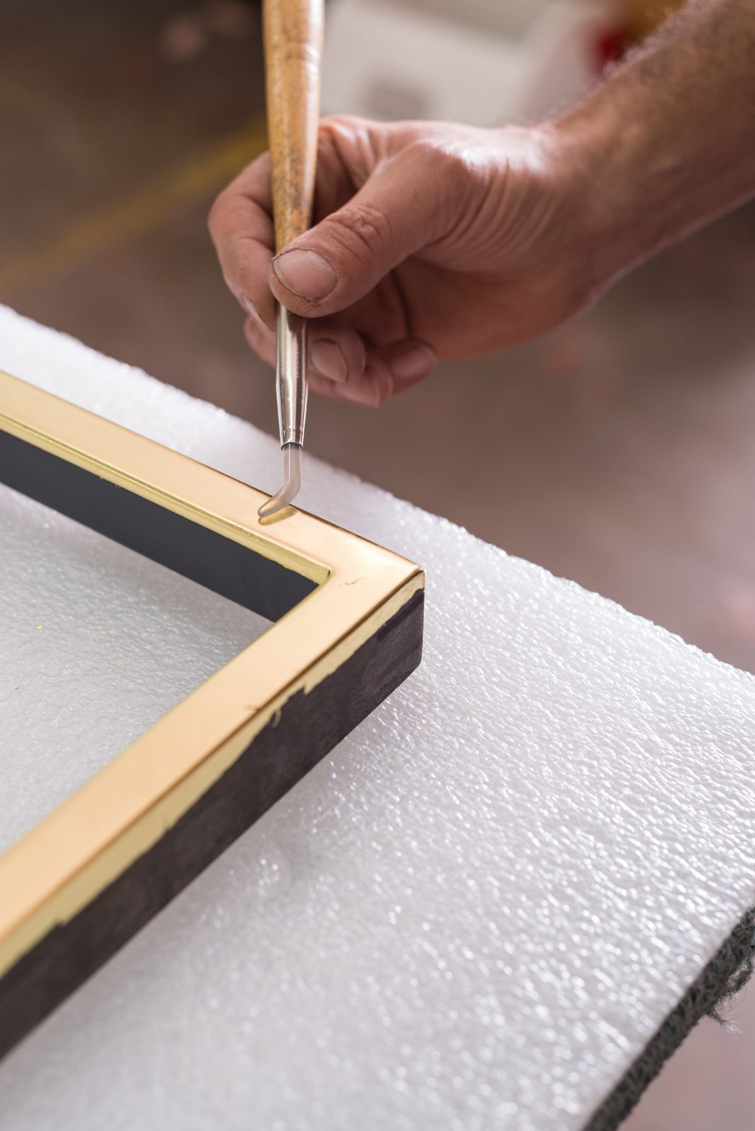 Burnishing a water-gilded frame with an agate stone, SBAS Houston