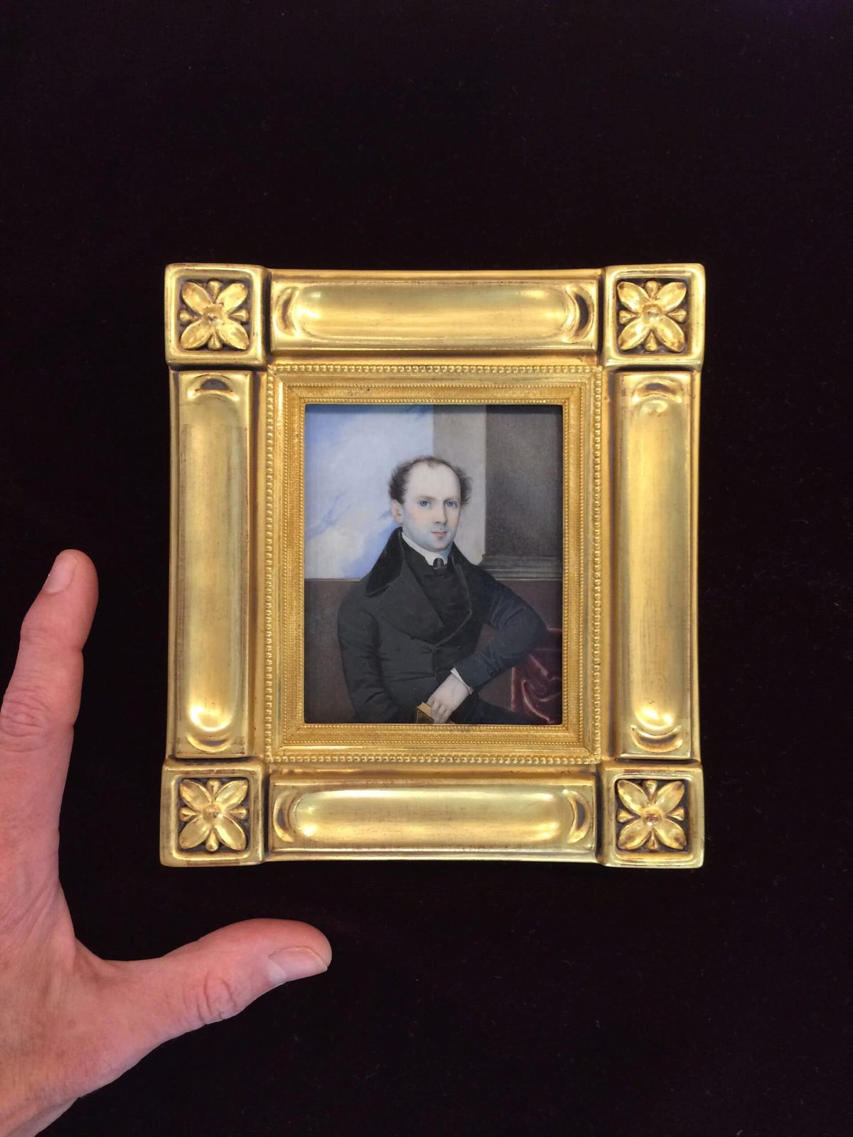 Hand-carved and gilded miniature portrait frame held in the maker's hand, SBAS Houston