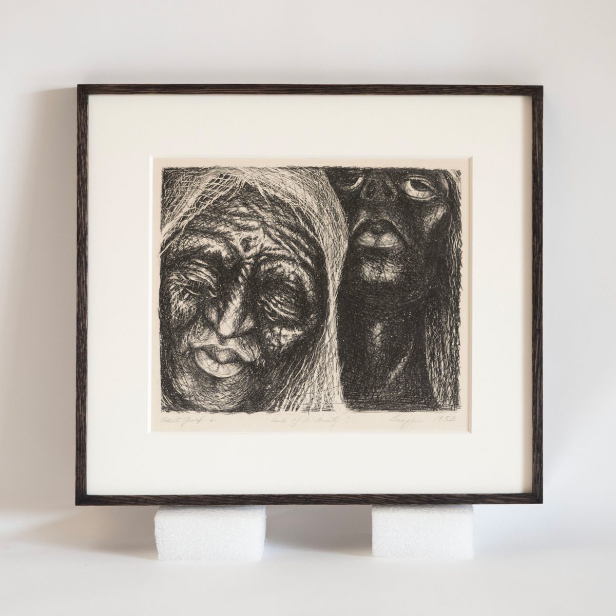 John Biggers lithograph Two Heads of Maternity in a black rub oak frame, SBAS Houston