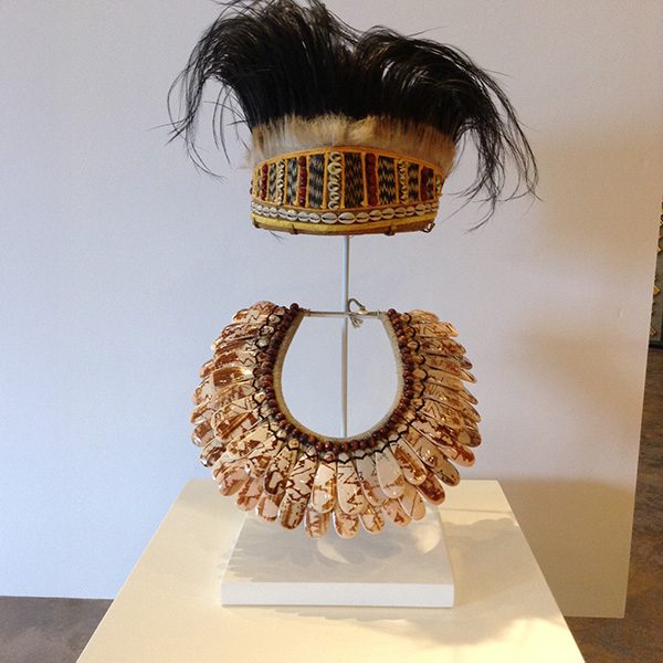 Headdress and necklace on a large freestanding pedestal for 360-degree viewing, SBAS Houston
