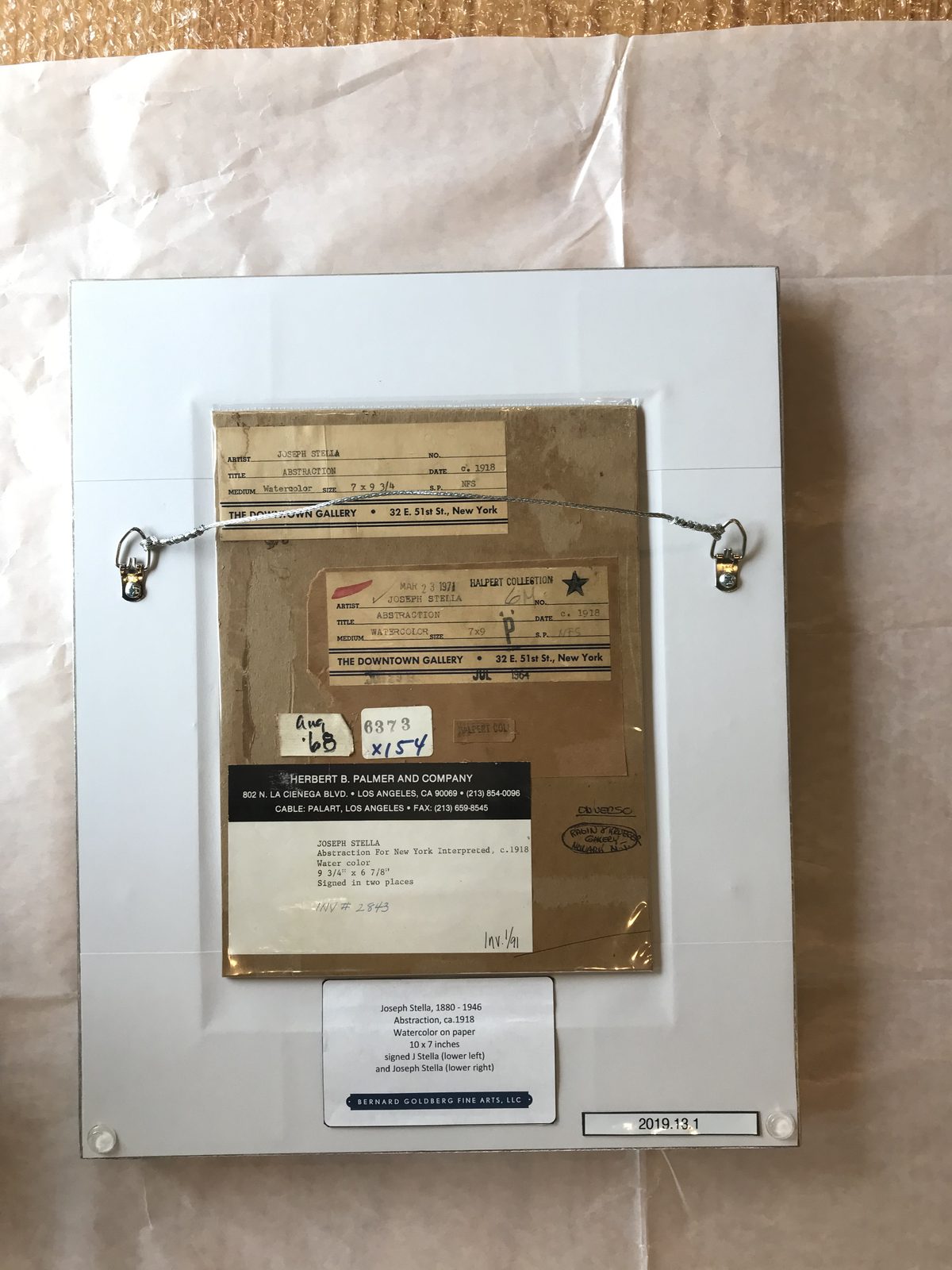 Gallery and exhibition labels on the back of a painting