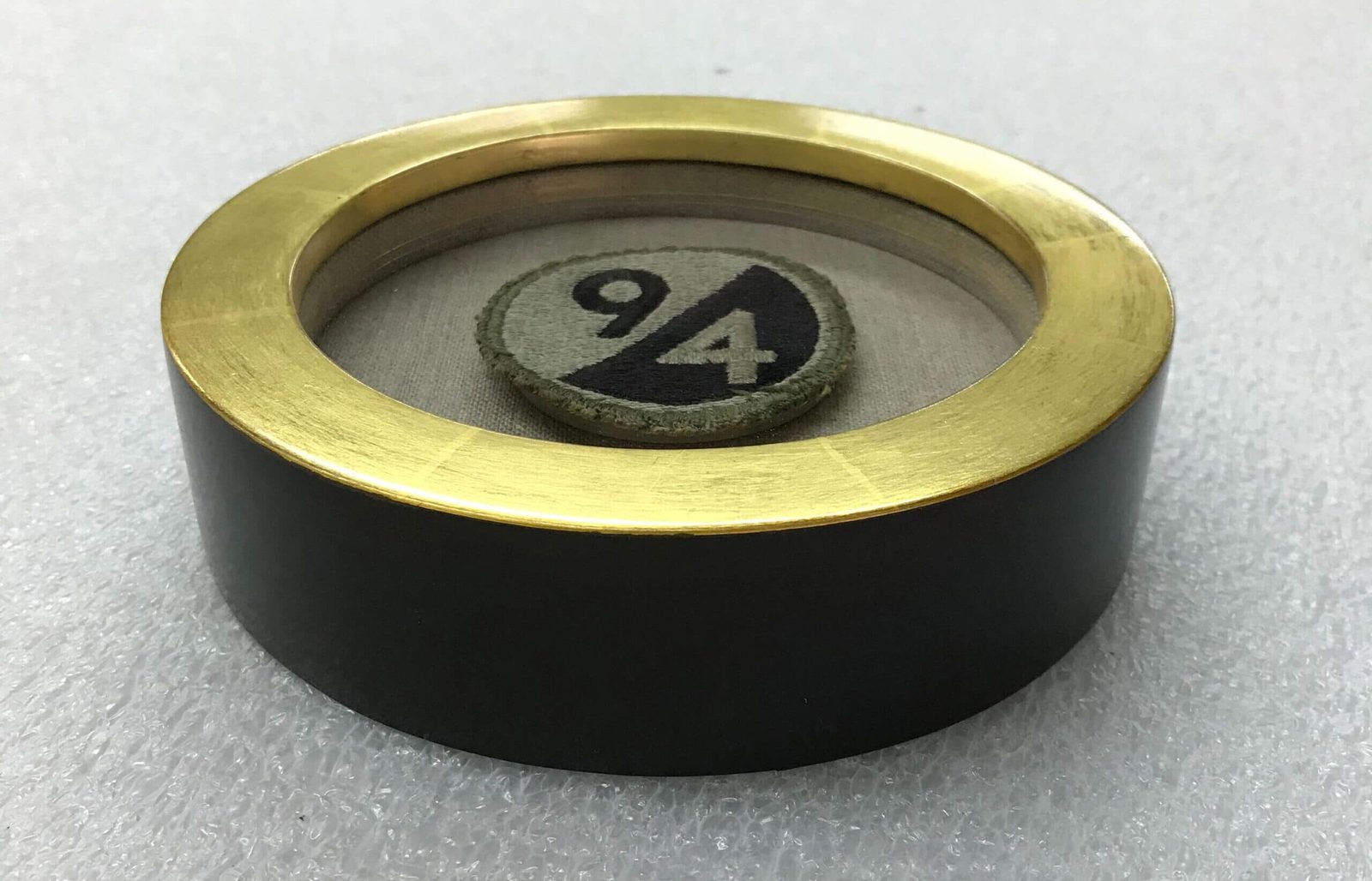 Round shadowbox object frame with gold bezel, SBAS Houston