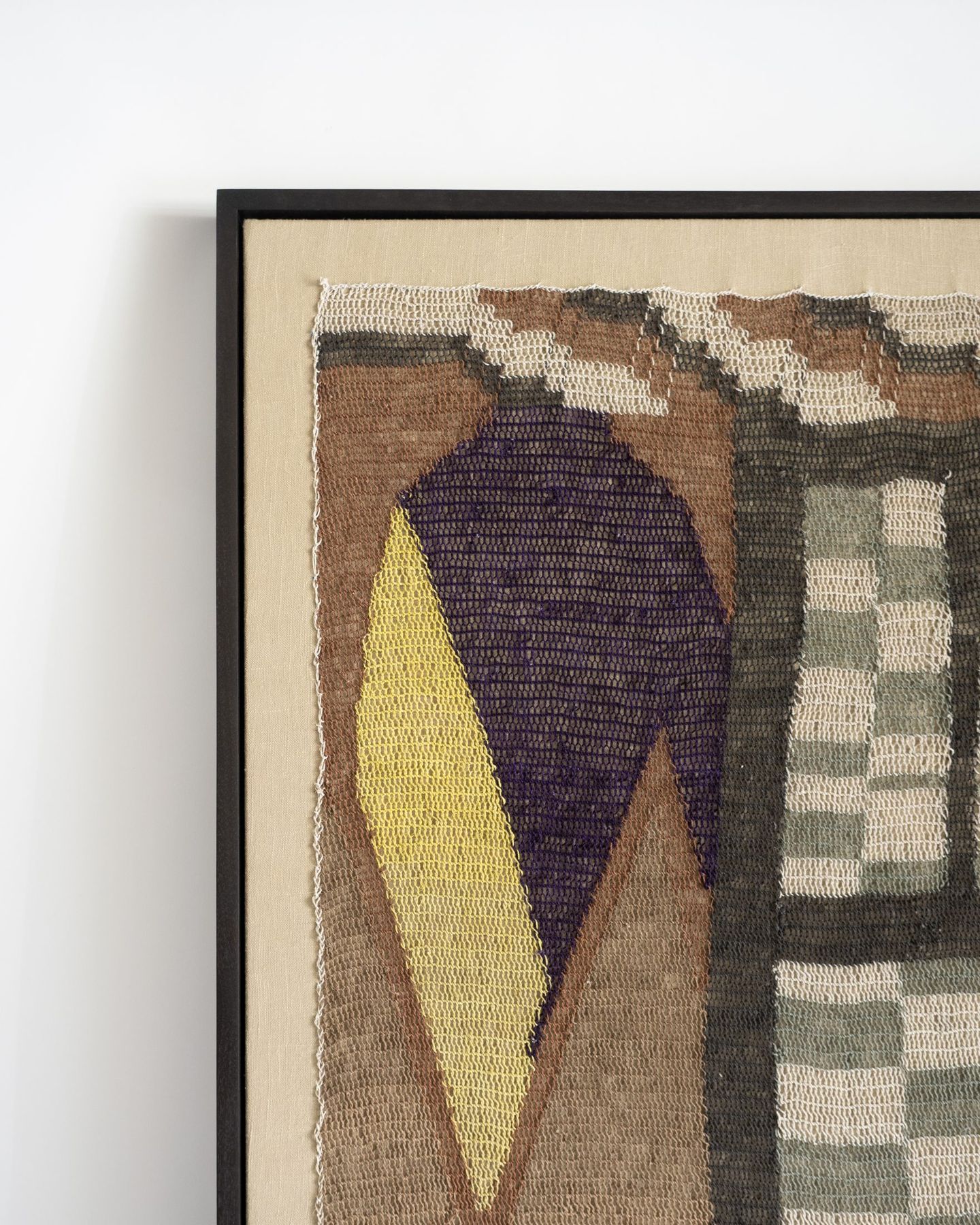 Corner detail of a framed tapestry showing weave and float mount, SBAS Houston